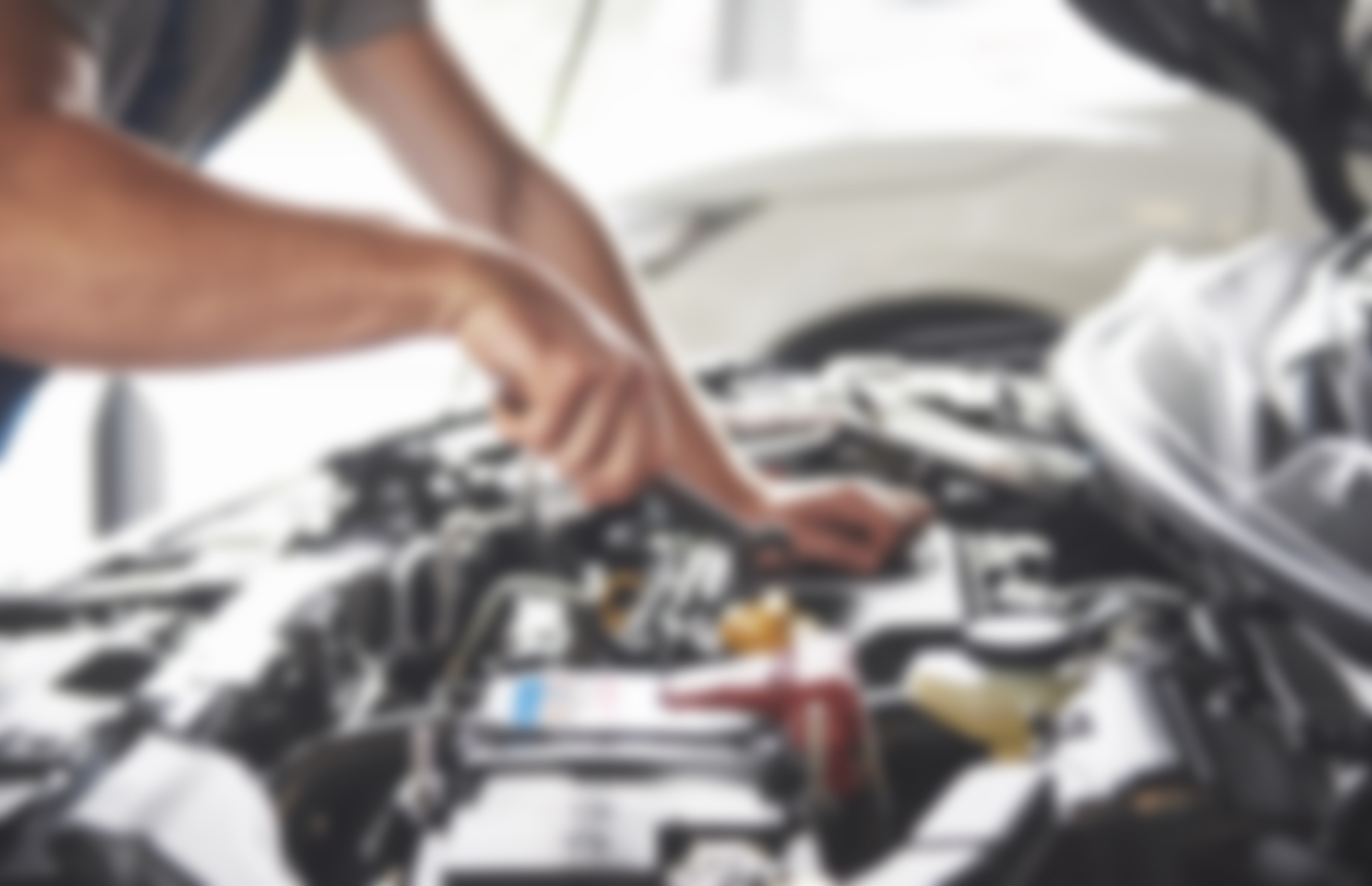 Mechanic working under the bonnet of a car